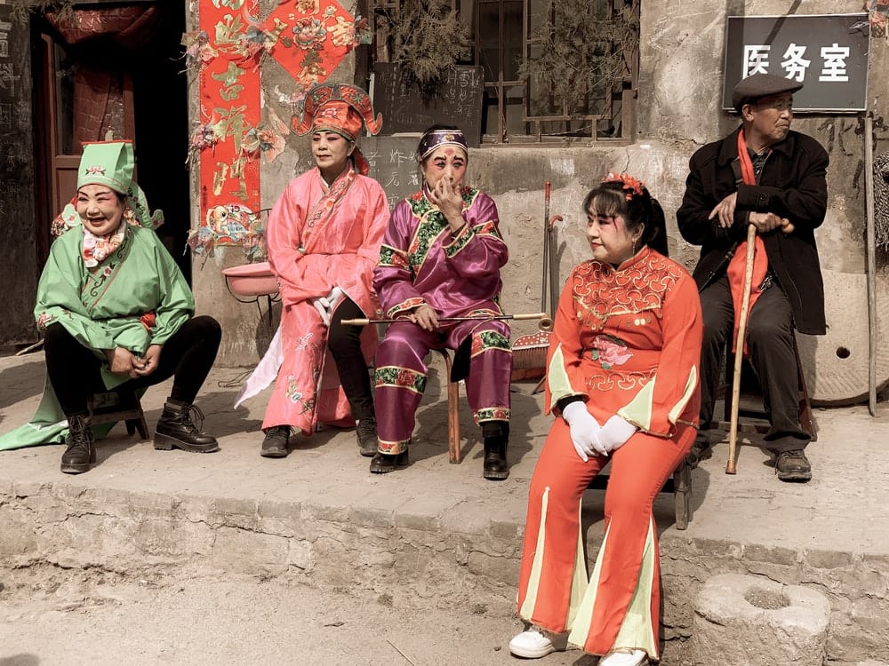 Paint By Numbers | Taiyuan - 3 Women In Red Traditional Dress Sitting On Concrete Bench