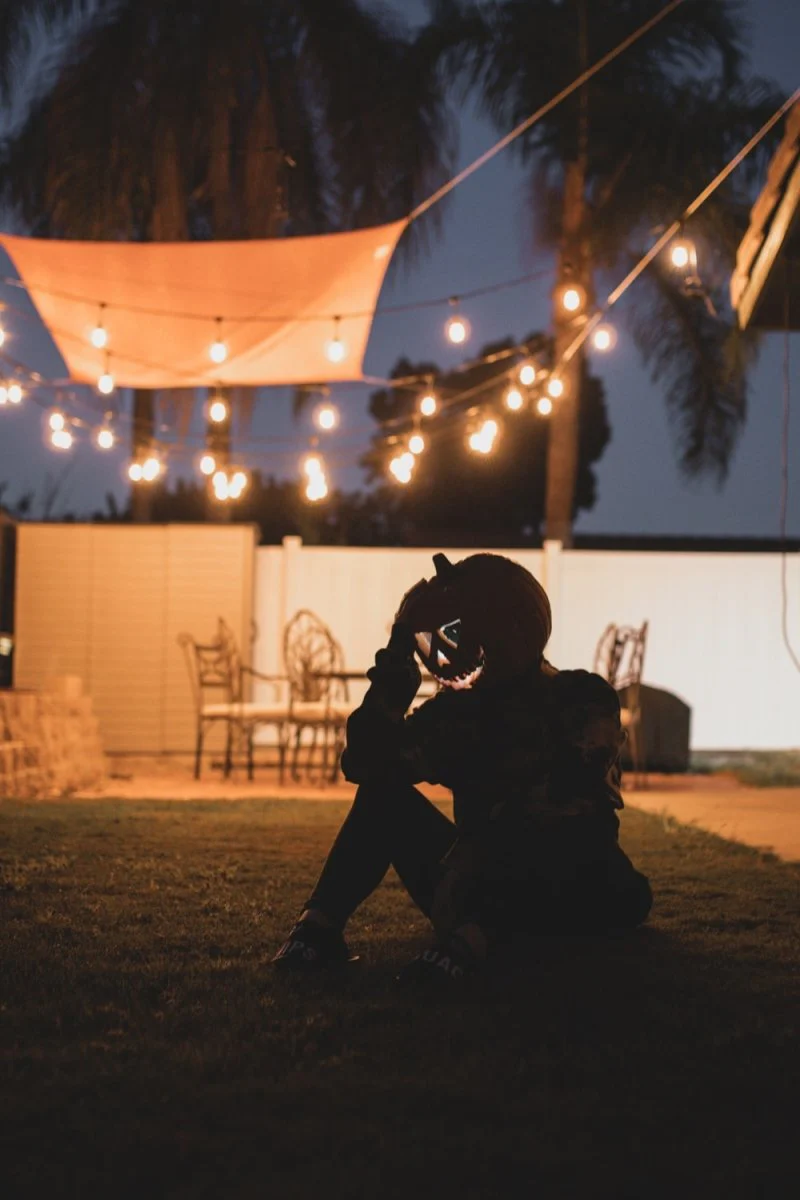Paint By Numbers | San Diego - Man In Black Jacket And Pants Sitting On Ground During Night Time