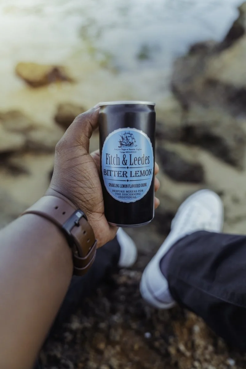 Paint By Numbers | Dar Es Salaam - Person Holding Blue And Black The Body Shop Bottle