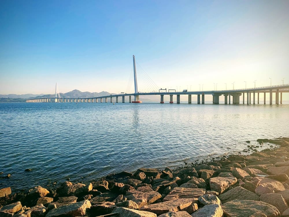 Paint By Numbers | Shenzhen - Rocks On Beach Near Bridge Under Blue Sky During Daytime
