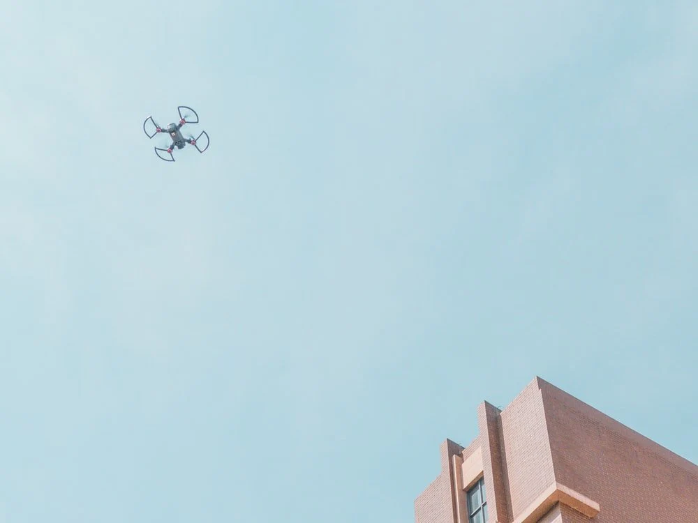 Paint By Numbers | Kunming - White Quadcopter Drone Fly Near Brown Concrete Building