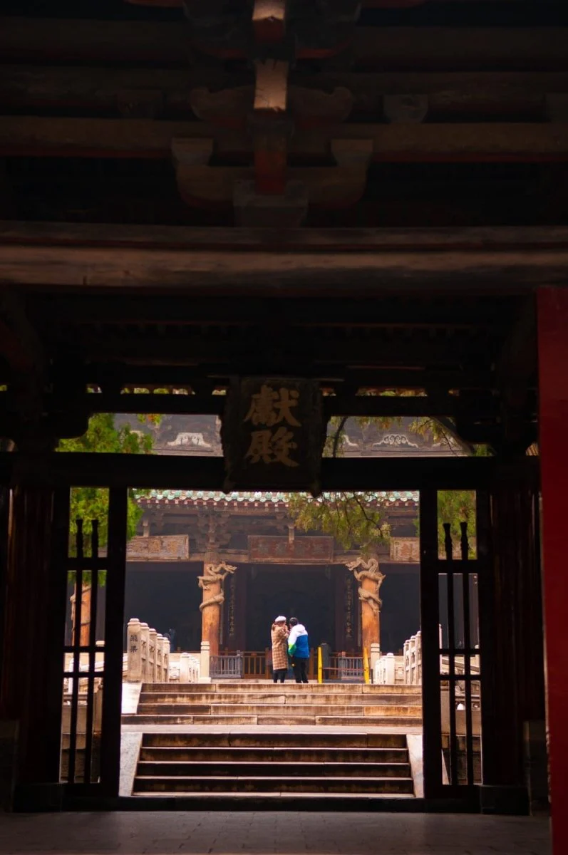 Paint By Numbers | Taiyuan - Woman In Blue Dress Standing On Brown Wooden Door